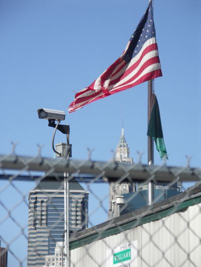 Flag and skyscraper; fence and camera #1