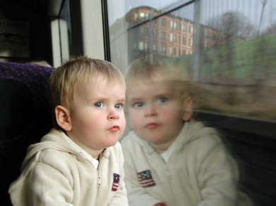 Alex on the train to Glasgow, looking out of the window.