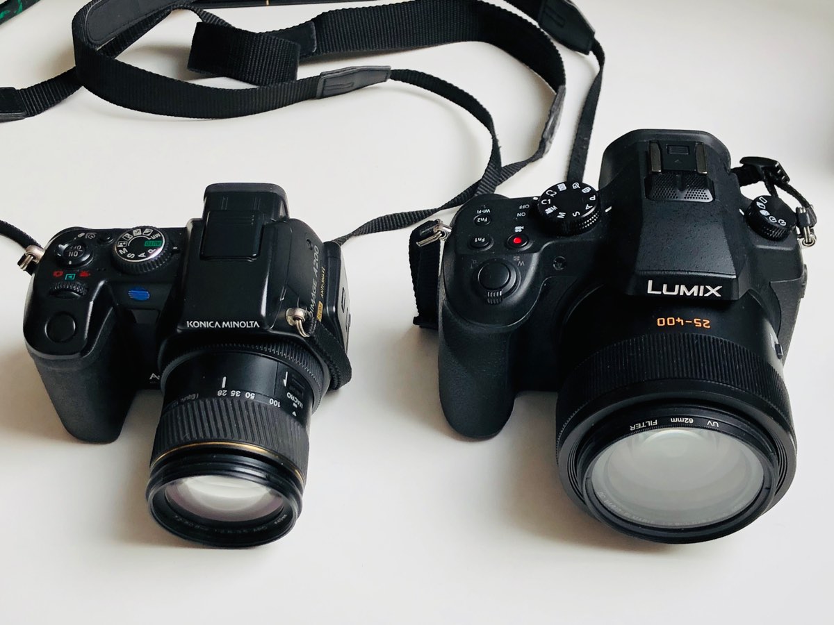 Two cameras side by side. A Konica Minolta DiMAGE A200 bought new in 2005, and aPanasonic Lumix FZ1000, bought second-hand in October 2018