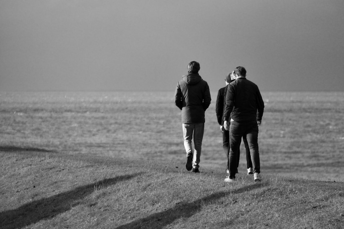 Men walking on the sea dyke at Hindeloopen